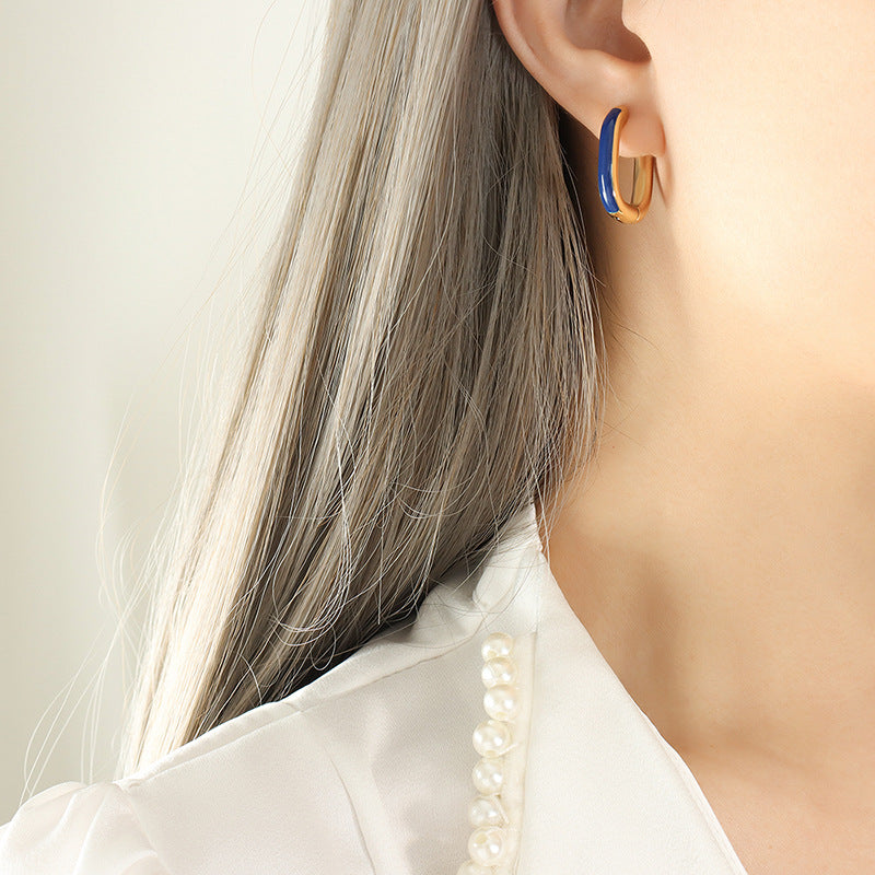 Gold PVD plated stainless steel U-shaped earrings with glossy enamel color accent, modern geometric design for women.