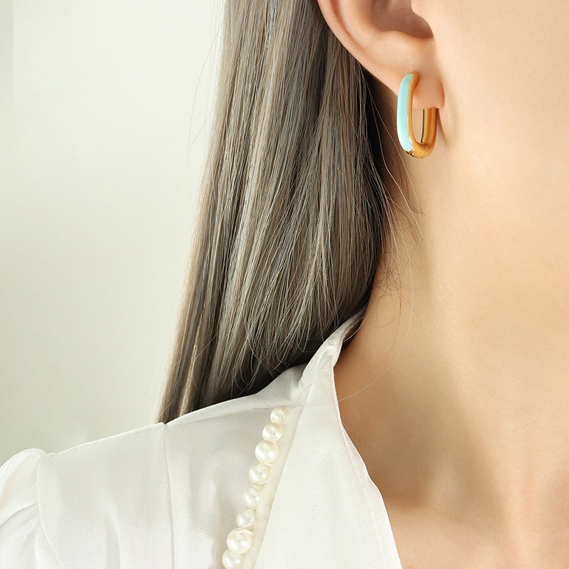 Gold PVD plated stainless steel U-shaped earrings with glossy enamel color accent, modern geometric design for women.