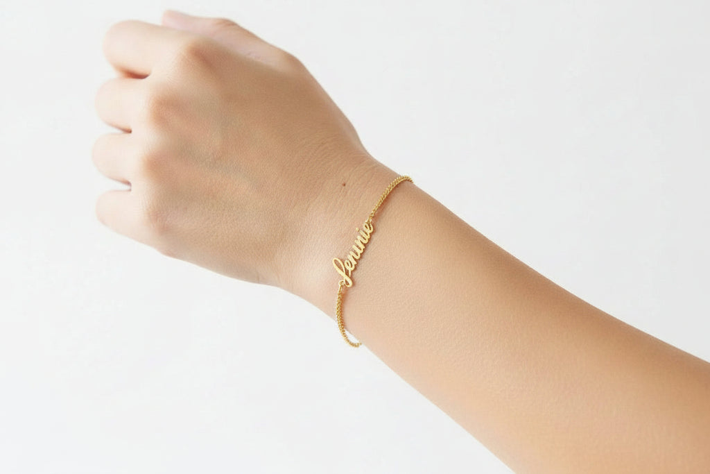 Personalized stainless steel name bracelet with custom letter design, adjustable 5.9–7.1 inches chain, gold finish worn on wrist.
