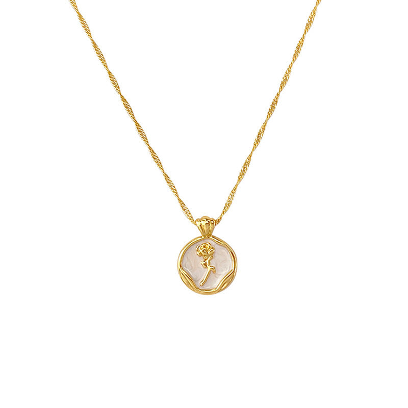 Gold PVD plated stainless steel necklace with round zircon flower pendant, minimalist floral design displayed on chain.