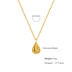 18K gold plated stainless steel water drop pendant necklace with concave geometric design and pearl accent, adjustable chain on white background