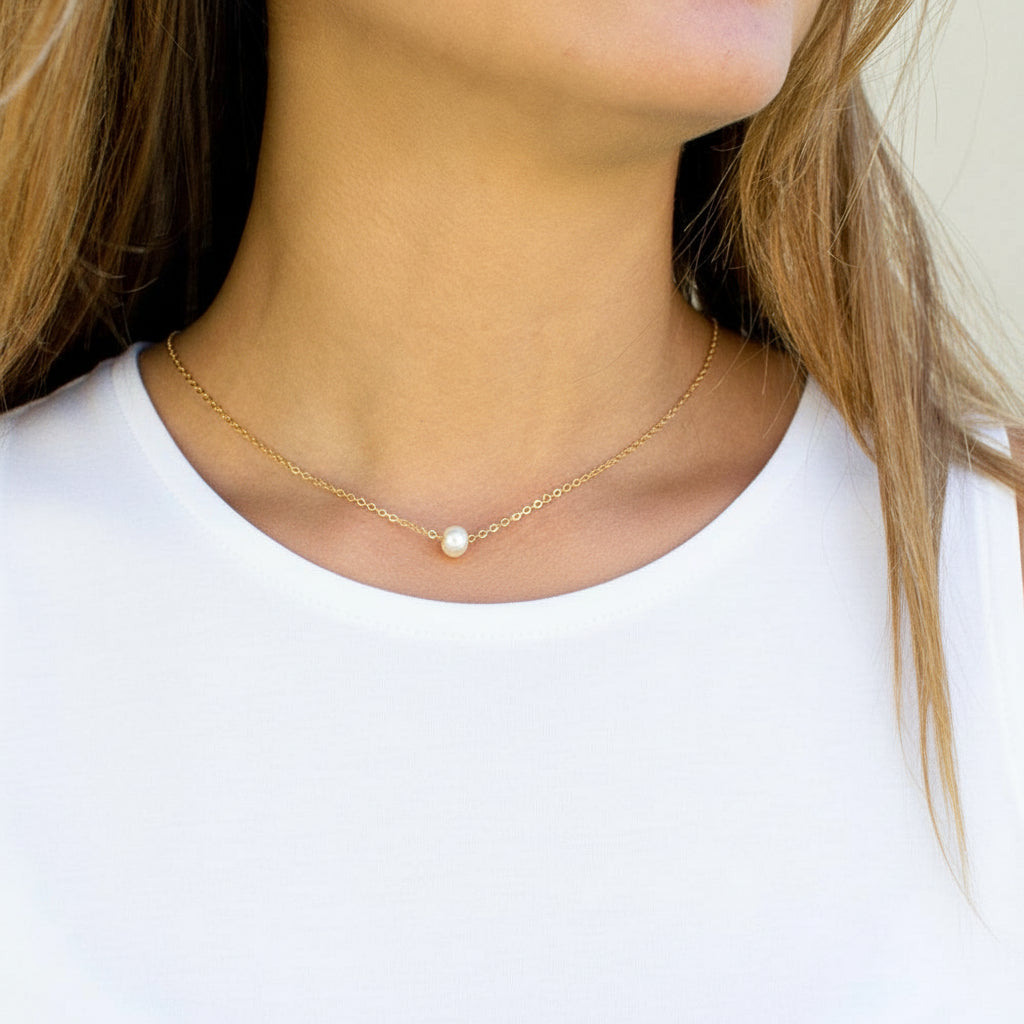 Minimalist stainless steel pearl choker necklace with 5mm pearl pendant, adjustable 15–17 inches chain, worn on model.