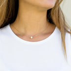 Minimalist stainless steel pearl choker necklace with 5mm pearl pendant, adjustable 15–17 inches chain, worn on model.