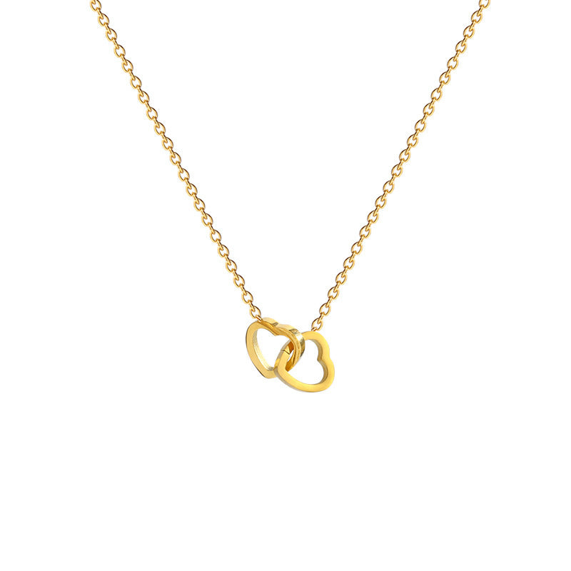 Stainless steel 18K gold PVD plated interlocking heart pendant necklace with minimalist geometric design on fine chain.