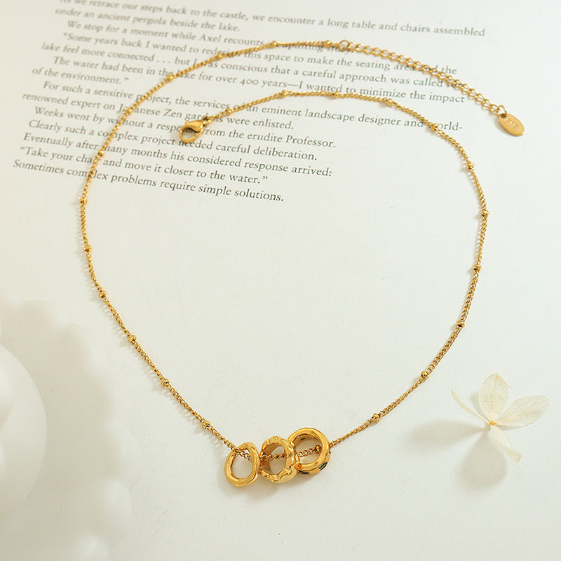 Three rings titanium steel pendant necklace with 18K gold plated finish, geometric trendy design, hypoallergenic women’s jewelry on white background