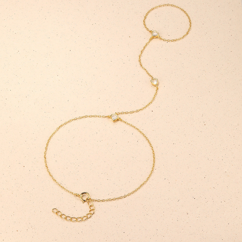 Gold plated 925 sterling silver hand chain bracelet with zirconia accents, adjustable finger bracelet design