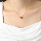 18K gold plated stainless steel geometric hollow pendant necklace with bead chain, adjustable unisex jewelry on white background