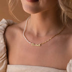 Personalized stainless steel paperclip chain necklace with pearl beads and custom name pendant, adjustable 15.7–17.7 inches, gold finish worn on model.