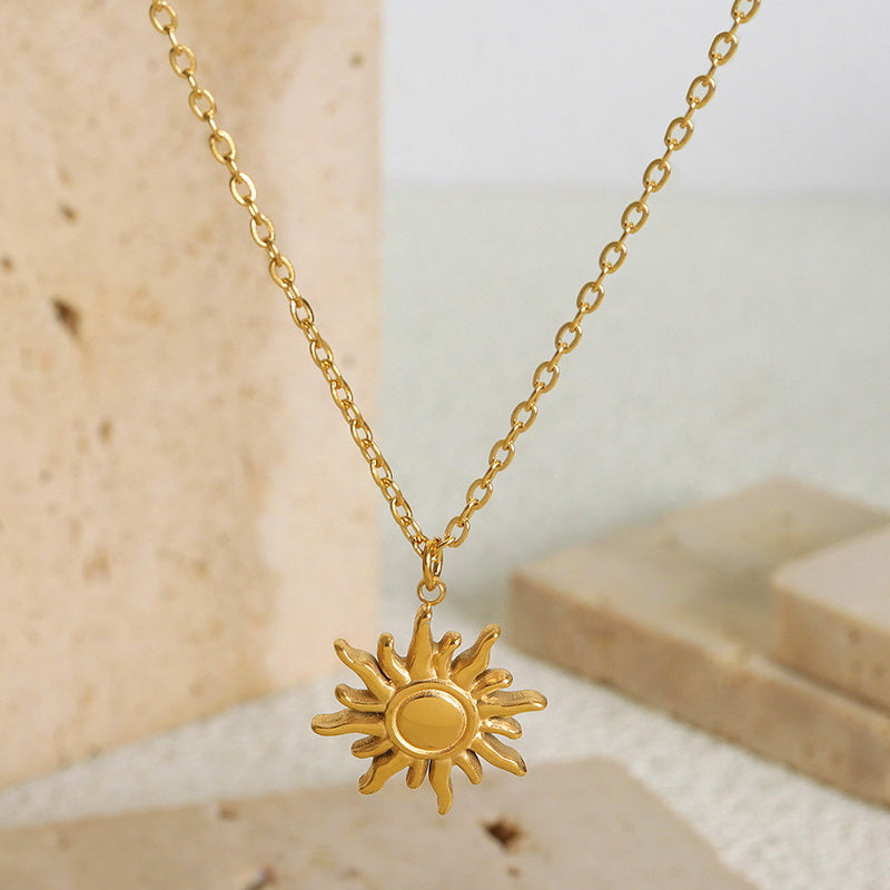 18K gold PVD plated stainless steel sun pendant necklace with geometric sun charm on fine chain.