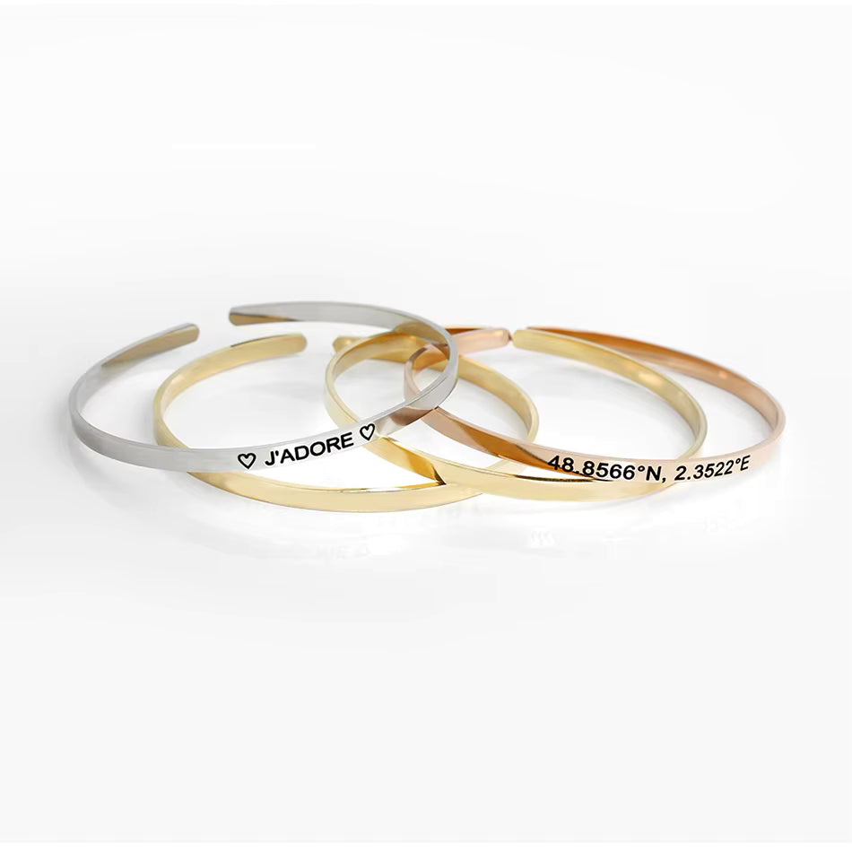 Minimalist 316L stainless steel engraved bar cuff bracelet with custom lettering, 4mm width, gold finish shown.