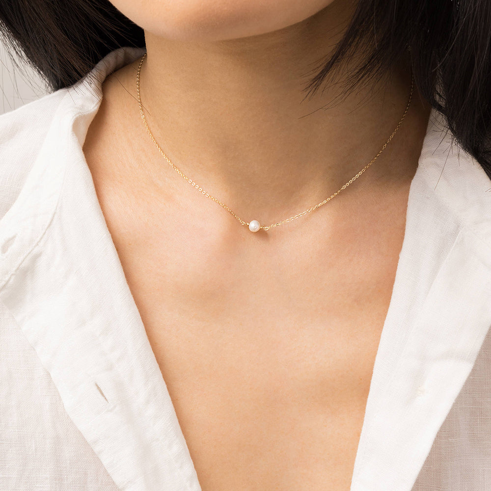 Minimalist stainless steel pearl choker necklace with 5mm pearl pendant, adjustable 15–17 inches chain, worn on model.