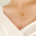 18K gold plated stainless steel geometric tassel pendant necklace with hollow square design and adjustable link chain on white background
