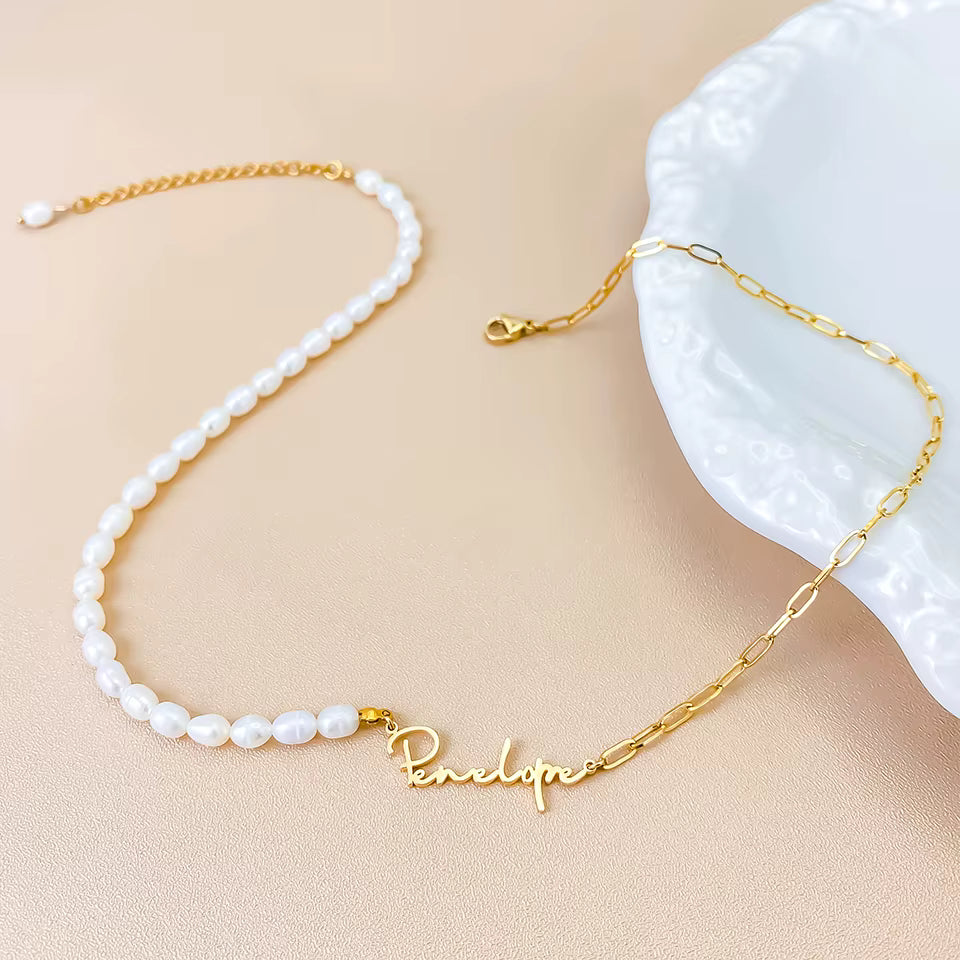 Personalized stainless steel paperclip chain necklace with pearl beads and custom name pendant, adjustable 15.7–17.7 inches, gold finish worn on model.