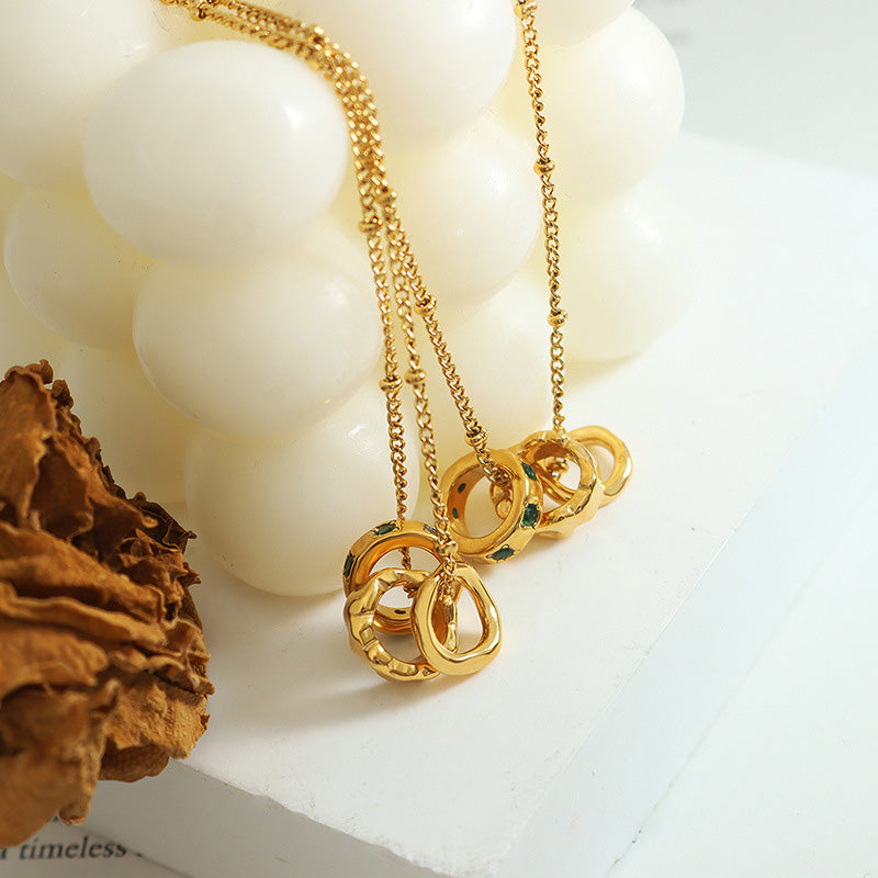 Three rings titanium steel pendant necklace with 18K gold plated finish, geometric trendy design, hypoallergenic women’s jewelry on white background