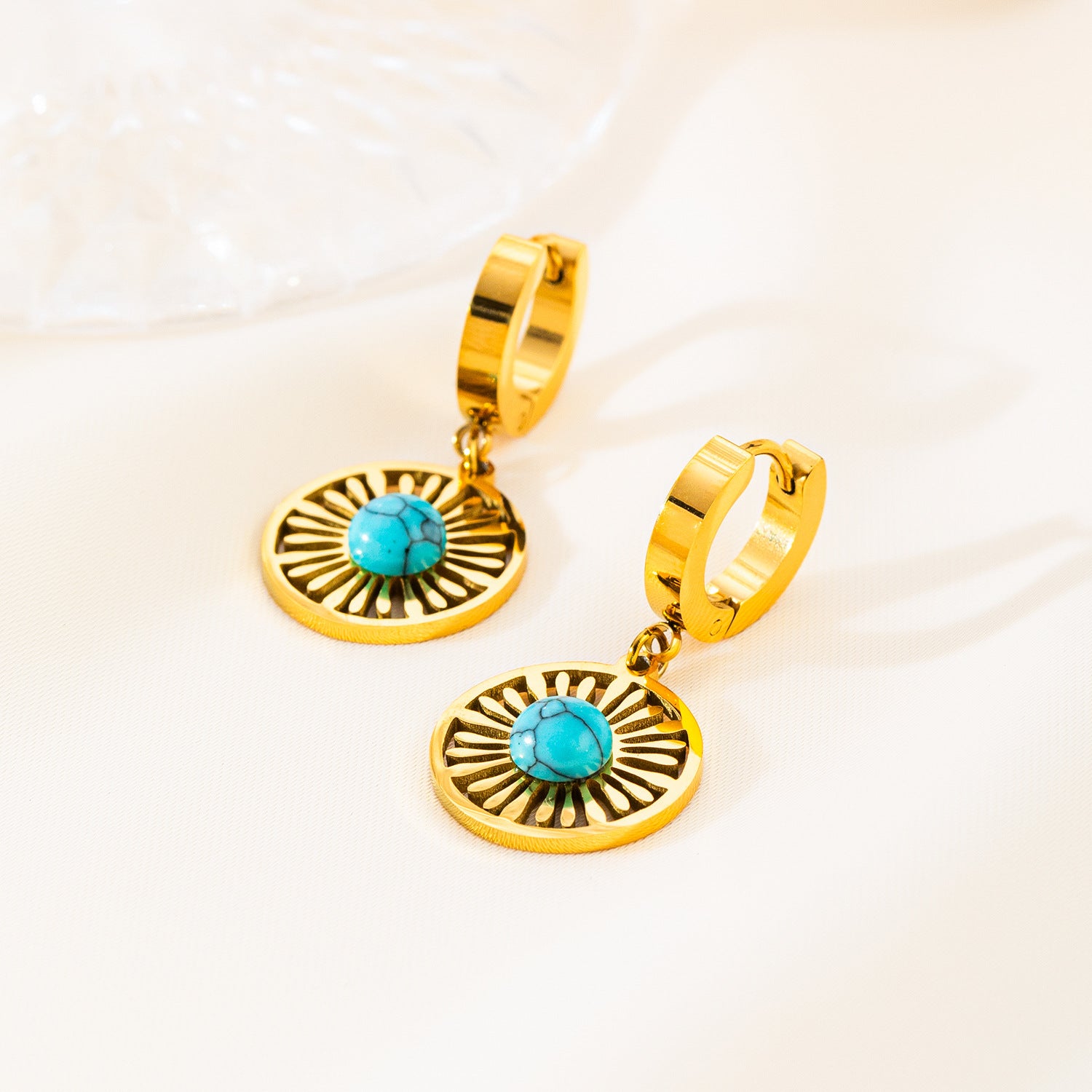 Gold plated stainless steel hoop earrings with round hollow geometric pendant, modern minimalist design for women.