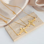 18K gold plated stainless steel heartbeat pendant necklace with geometric pulse design and adjustable link chain on white background
