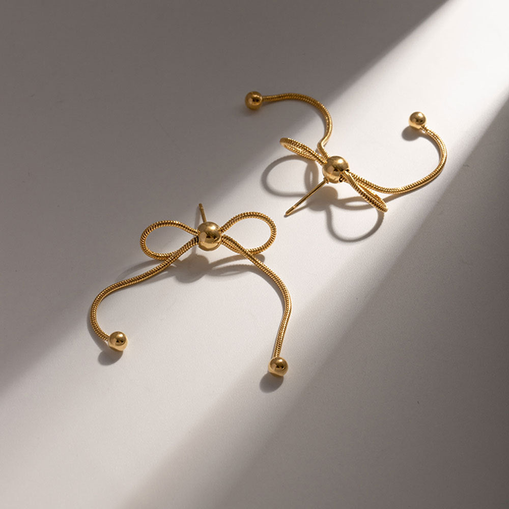 18K gold PVD plated stainless steel bow knot drop earrings with delicate chain design and polished bead accents for women