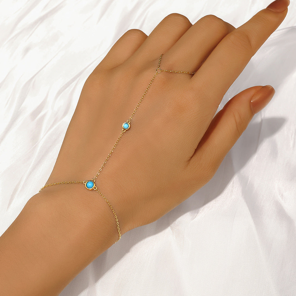 Gold plated 925 sterling silver hand chain bracelet with round turquoise stone and finger loop design