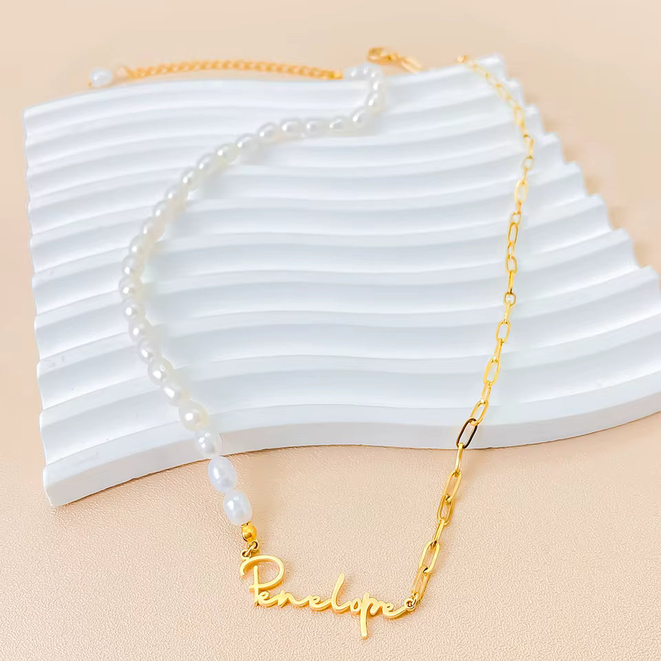 Personalized stainless steel paperclip chain necklace with pearl beads and custom name pendant, adjustable 15.7–17.7 inches, gold finish worn on model.