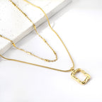 18K gold plated stainless steel engraved geometric pendant necklace with pearl accent, layered link chains, trendy women’s jewelry on white background