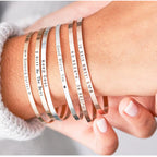 Minimalist 316L stainless steel engraved bar cuff bracelet with custom lettering, 4mm width, gold finish shown.