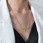 18K gold plated stainless steel heartbeat pendant necklace with geometric pulse design and adjustable link chain on white background
