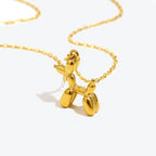 18K gold plated stainless steel balloon dog pendant necklace with cute animal design on a link chain, unisex jewelry on white background
