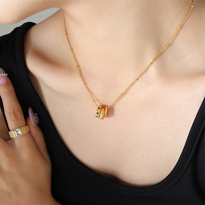 Three rings titanium steel pendant necklace with 18K gold plated finish, geometric trendy design, hypoallergenic women’s jewelry on white background