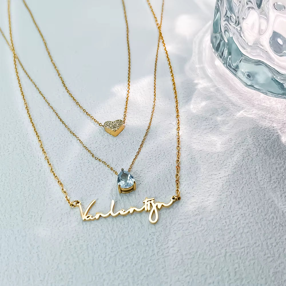 Custom layered name necklace in stainless steel with teardrop zirconia pendant, 14K gold color, adjustable chains and personalized name design