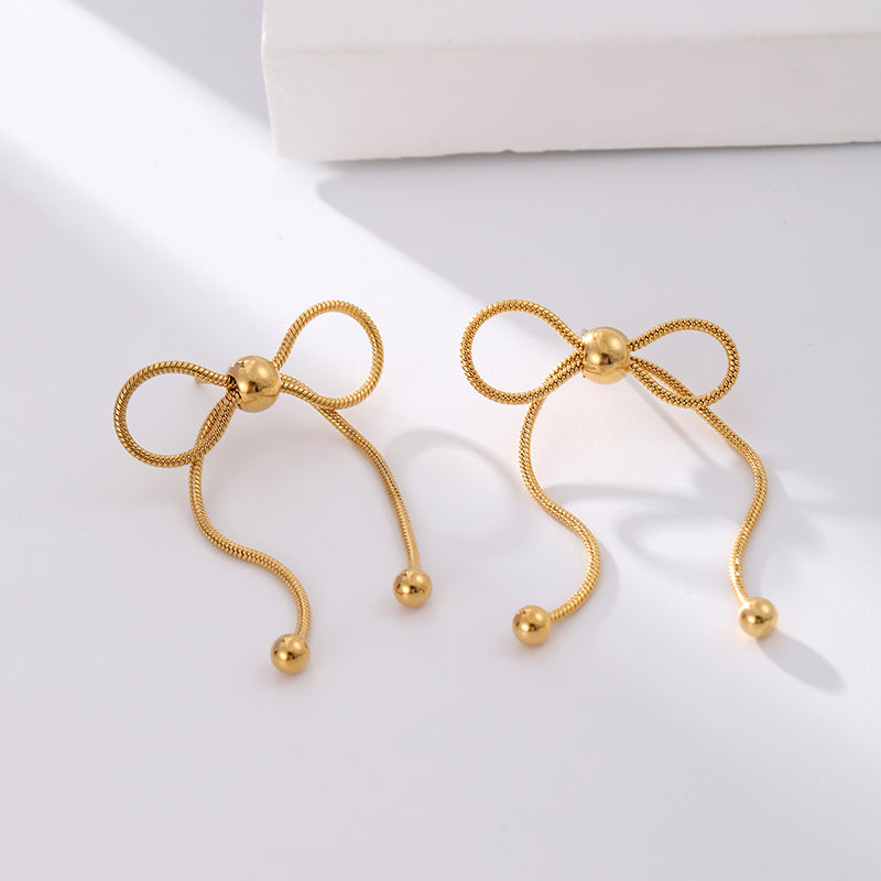 18K gold PVD plated stainless steel bow knot drop earrings with delicate chain design and polished bead accents for women