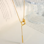 18K gold plated stainless steel geometric tassel pendant necklace with hollow square design and adjustable link chain on white background