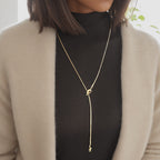 18K gold plated stainless steel knotted pendant necklace with long adjustable chain, geometric trendy women’s jewelry on white background