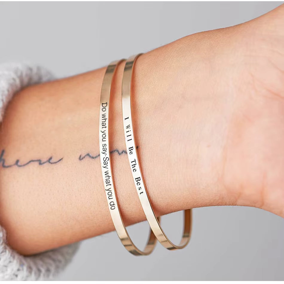 Minimalist 316L stainless steel engraved bar cuff bracelet with custom lettering, 4mm width, gold finish shown.