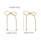18K gold PVD plated stainless steel bow knot drop earrings with delicate chain design and polished bead accents for women