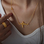 18K gold plated stainless steel heartbeat pendant necklace with geometric pulse design and adjustable link chain on white background
