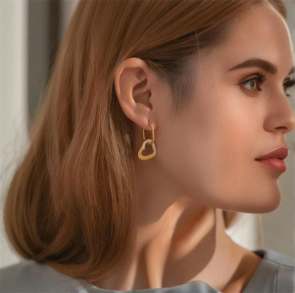 Gold plated stainless steel heart hoop earrings with zircon accents, geometric heart design, 3.6 × 1.9 cm size.