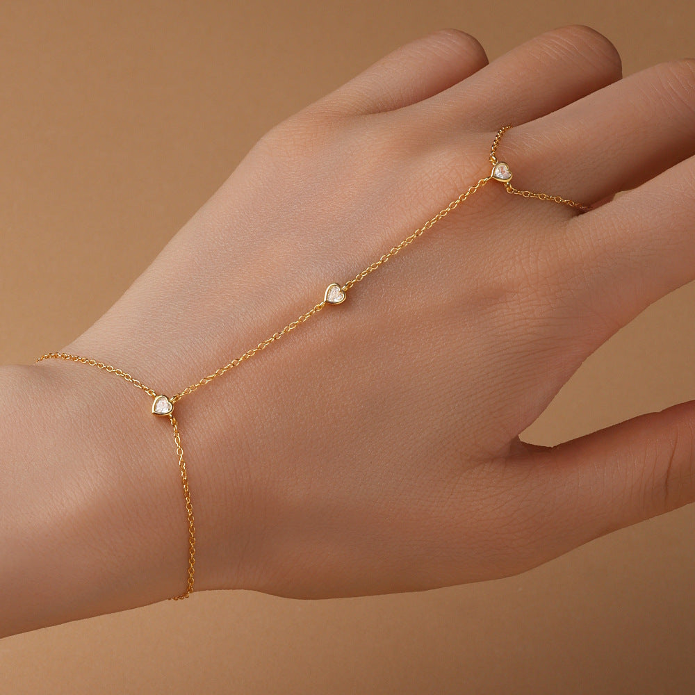 Gold plated 925 sterling silver hand chain bracelet with zirconia accents, adjustable finger bracelet design