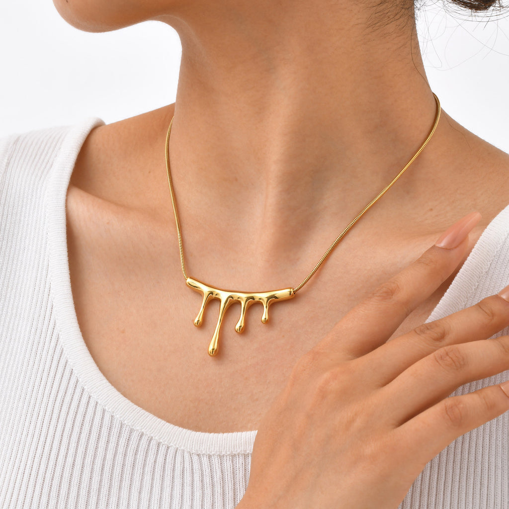 18K gold plated stainless steel lava drop pendant necklace with irregular geometric design and adjustable chain on white background