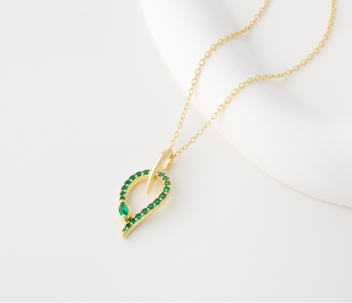 Gold plated S925 sterling silver snake pendant necklace with green stones on a delicate chain, elegant jewelry for women.
