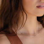 Custom stainless steel birthstone monogram necklace with personalized initial and month stone, eco-friendly and nickel-free.