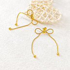 18K gold PVD plated stainless steel bow knot drop earrings with delicate chain design and polished bead accents for women