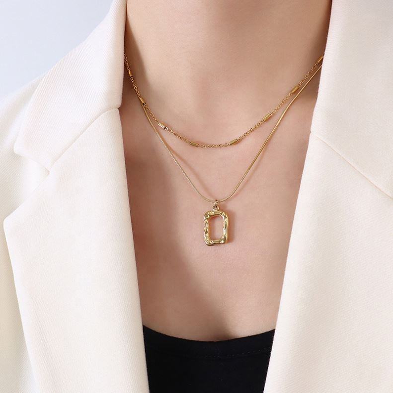 18K gold plated stainless steel engraved geometric pendant necklace with pearl accent, layered link chains, trendy women’s jewelry on white background