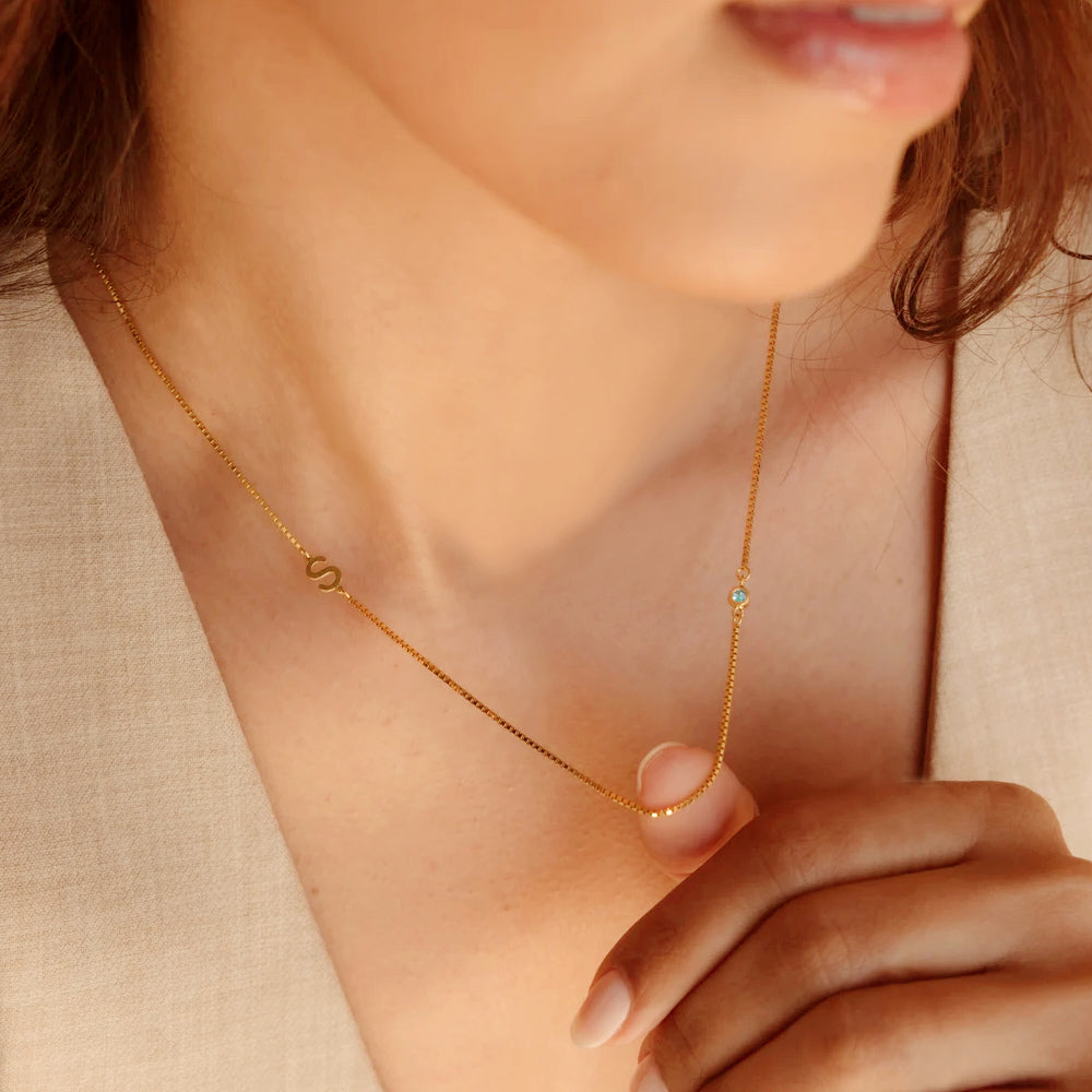 Custom stainless steel birthstone monogram necklace with personalized initial and month stone, eco-friendly and nickel-free.