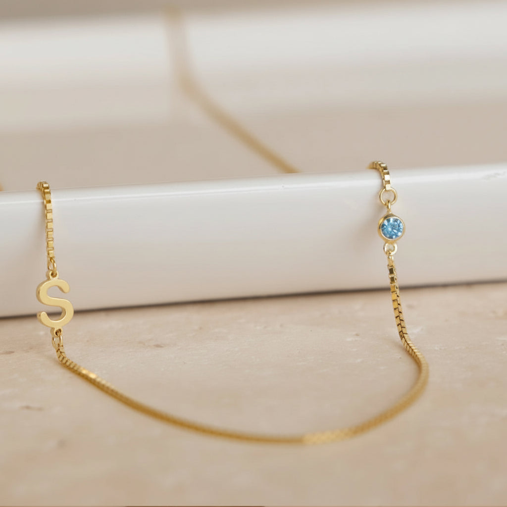 Custom stainless steel birthstone monogram necklace with personalized initial and month stone, eco-friendly and nickel-free.