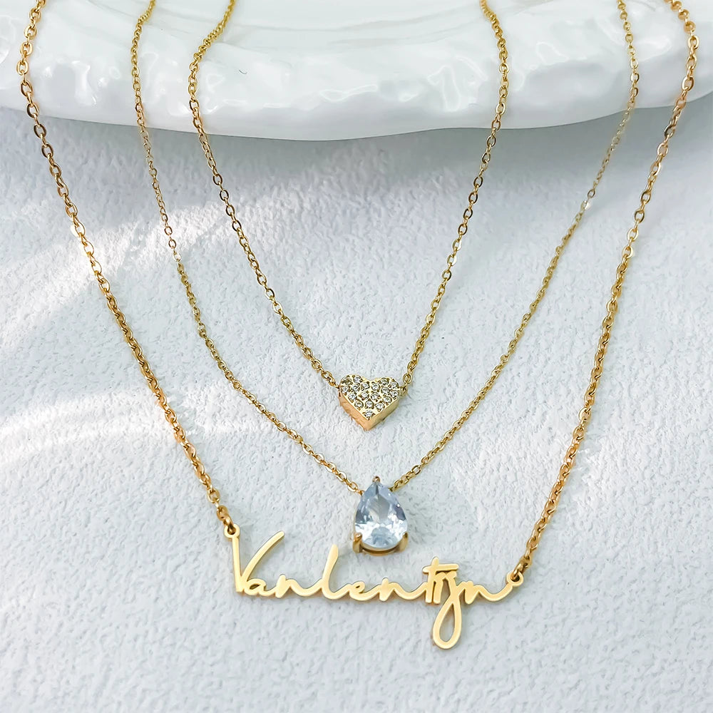 Custom layered name necklace in stainless steel with teardrop zirconia pendant, 14K gold color, adjustable chains and personalized name design