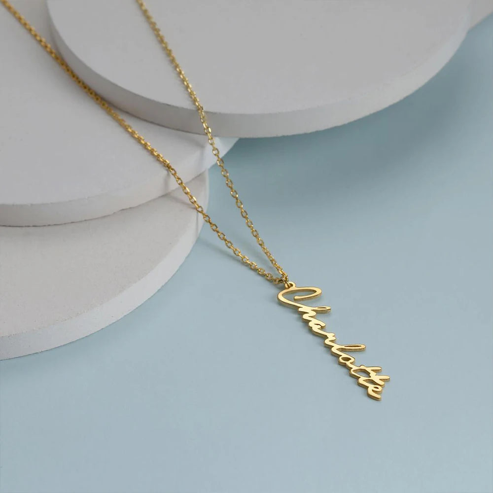 Personalized stainless steel handwritten vertical name necklace with custom letter pendant, adjustable 15.7–17.7 inches chain, gold finish shown on hand.