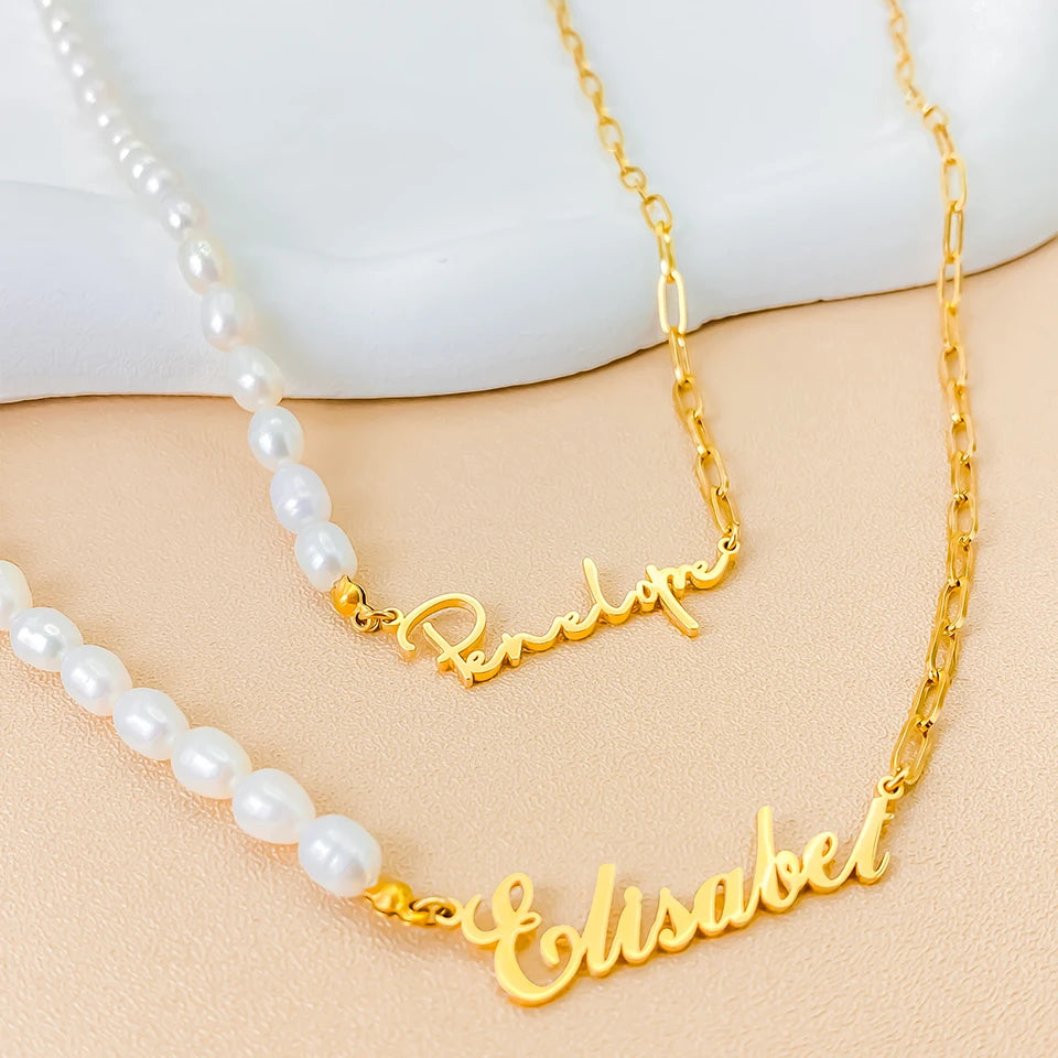 Personalized stainless steel paperclip chain necklace with pearl beads and custom name pendant, adjustable 15.7–17.7 inches, gold finish worn on model.